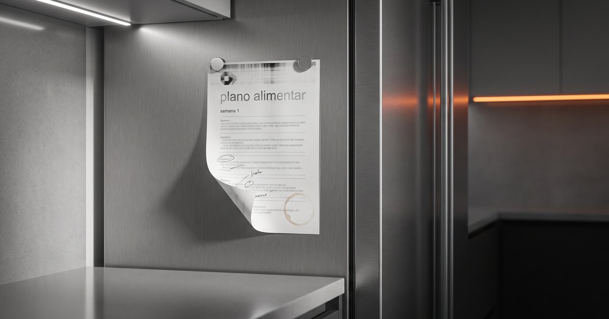 Folha de plano alimentar impressa em casa presa por dois ímãs na porta de uma geladeira de aço escovado, com faixas de falha de tinta no cabeçalho, uma marca gráfica esticada e pixelada no canto, anotações a caneta por cima do texto e o canto de baixo amassado